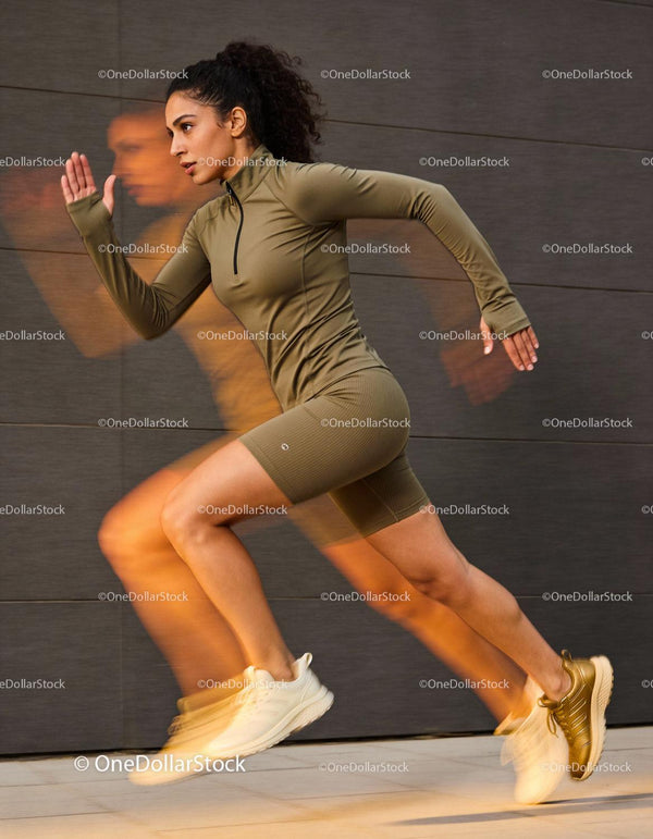 Athletic woman sprinting energetically on urban pavement