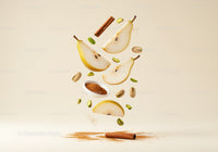 Fresh pear slices with cinnamon and pistachios floating