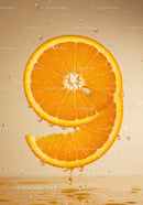 Fresh orange slices dripping with juice in water