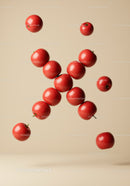 Bright red apples floating on beige background
