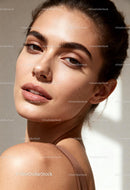 Portrait of young woman with glowing natural skin
