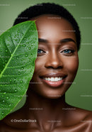 Portrait of a Smiling Black Woman with Bright Eyes and Green Leaf