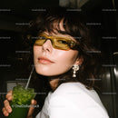 Elegant Woman with Sunglasses Holding Mojito in Nightlife Setting