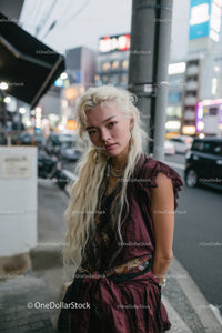 Fashionable Young Woman in Streetwear on City Street at Night