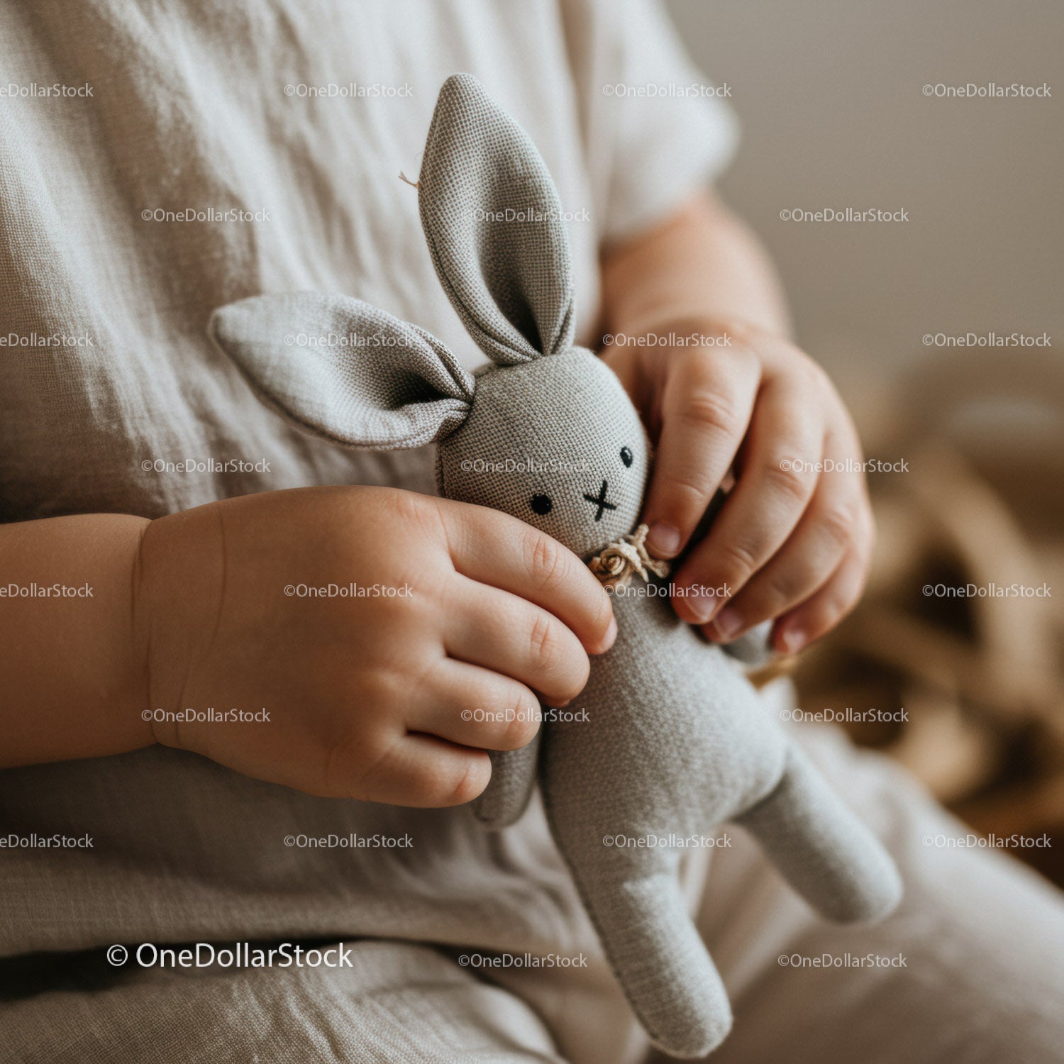 Toddler holding soft fabric bunny toy close up
