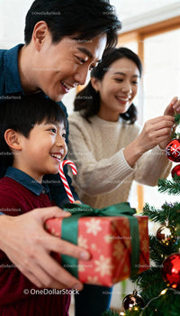 Happy family decorating Christmas tree together at home