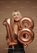 Smiling woman celebrating eighteenth birthday with balloons