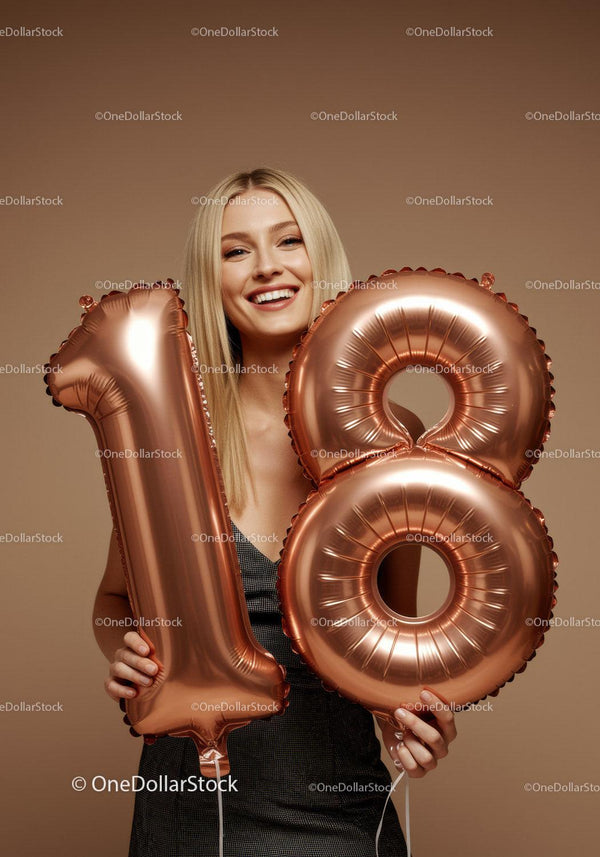 Smiling woman celebrating eighteenth birthday with balloons