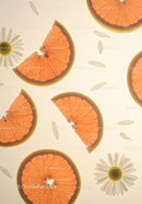 Fresh grapefruit slices with delicate daisies on light
