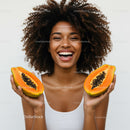 Vibrant Woman Holding Juicy Papaya Slices for Healthy Lifestyle