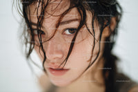 Close-up of Young Woman with Wet Hair and Water Droplets
