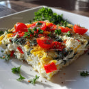 Vegetable Frittata with Cherry Tomatoes and Herbs on White Plate