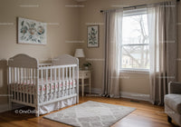 Bright and Cozy Nursery with White Crib and Floral Wall Art