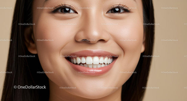Close-up of smiling young woman with smooth skin
