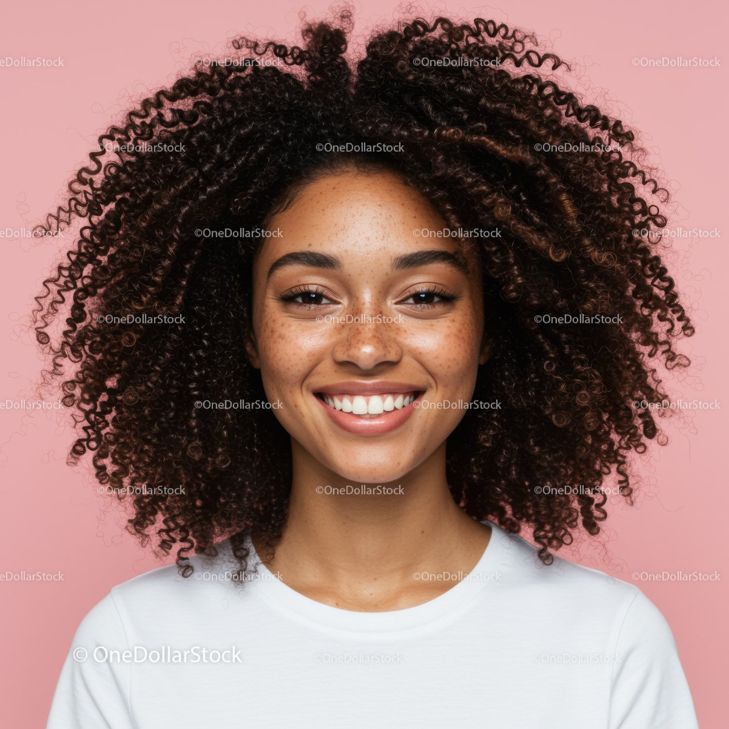 Young Woman with Curly Hair and Freckles on Bright Pink Background
