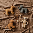 Handmade soft animal toys on warm brown fabric