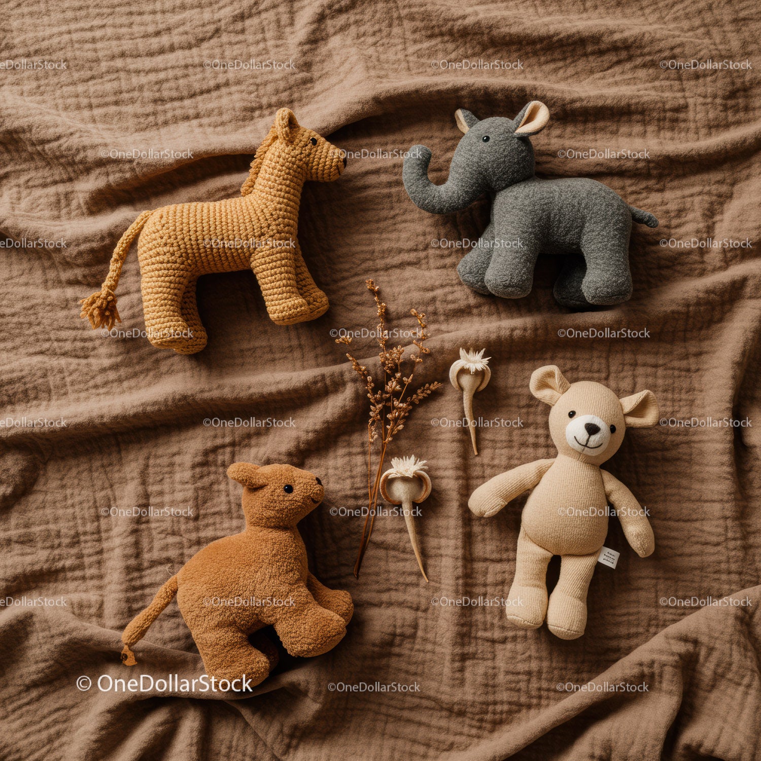 Handmade soft animal toys on warm brown fabric