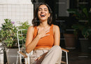 Joyful Woman Laughing and Relaxing Outdoors in Bright Sunlight