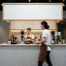 Baristas preparing coffee in modern minimalist cafe interior