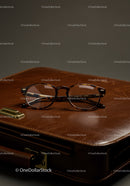 Elegant Brown Acetate Glasses on Leather Briefcase in Office Setting