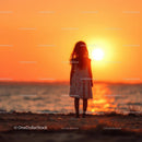 Silhouette of a Child at Sunset by the Ocean Shore