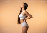 Slim Young Woman in White Sportswear Posing for Wellness and Fitness
