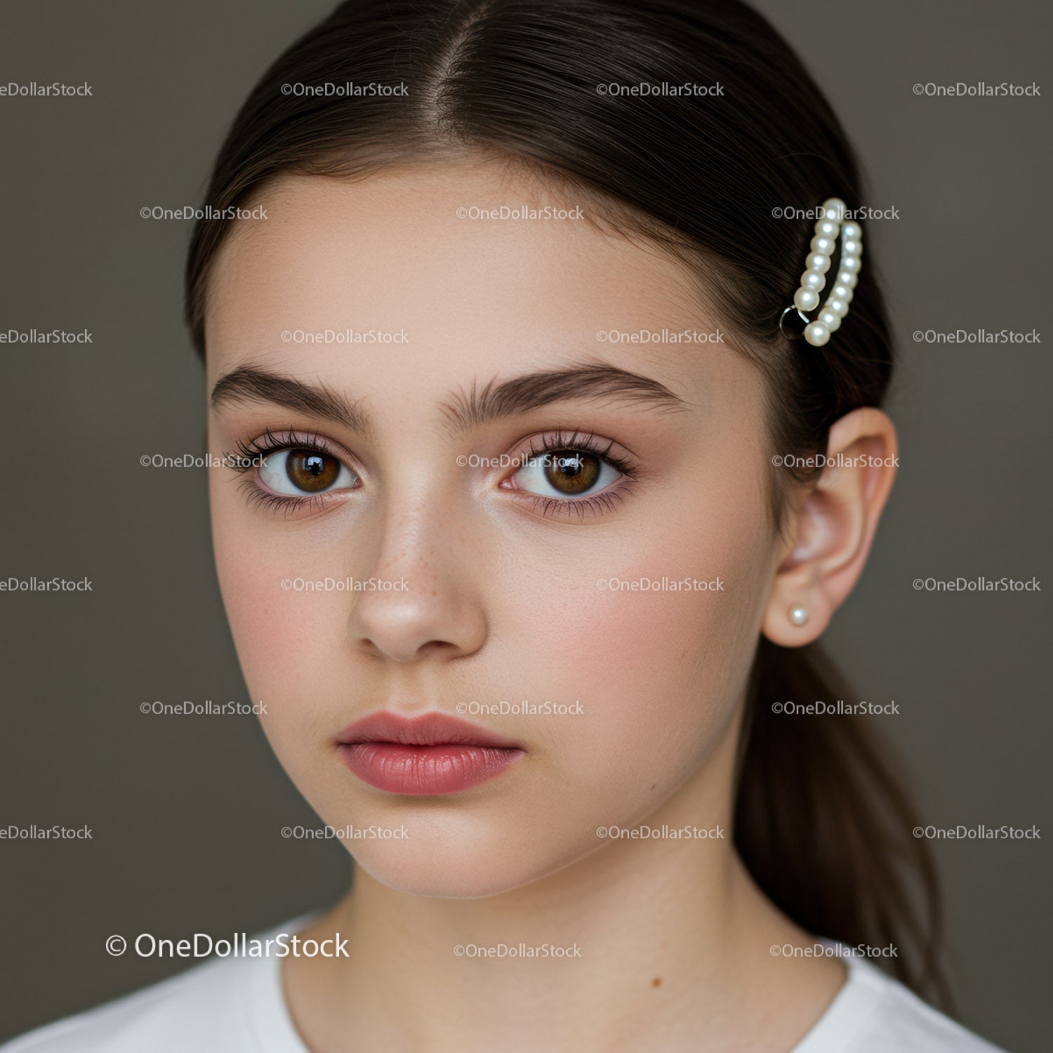 Portrait of a Young Woman with Pearl Hair Clips and Natural Makeup