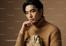 Stylish Young Man in Beige Turtleneck Holding a Beige Clutch in Studio