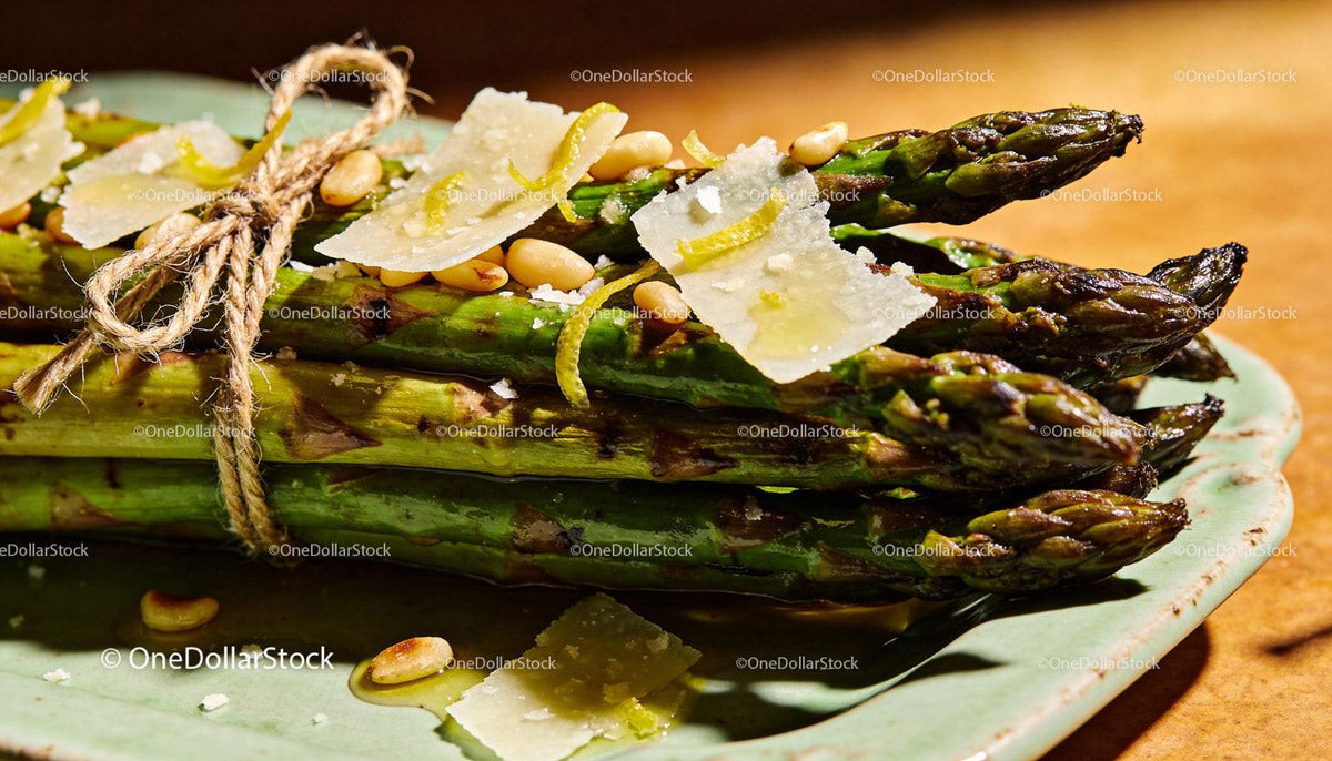 Grilled asparagus bundle with pine nuts and cheese