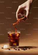 Hand pouring coffee concentrate into iced glass