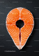 Fresh salmon steak on black textured surface