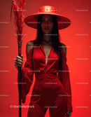 Elegant Woman in Red Dress with Accessories Against Red Background