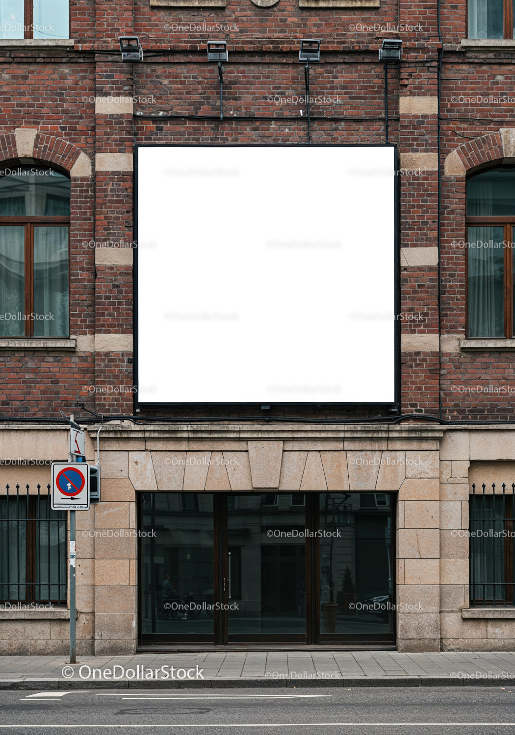 Blank white billboard on brick building facade