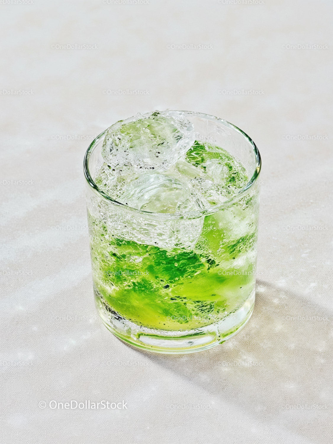 Refreshing Lime Drink with Ice Cubes on Light Surface