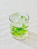 Refreshing Lime Drink with Ice Cubes on Light Surface