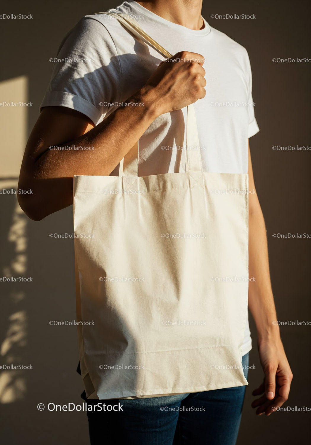 Man holding blank cotton tote bag with natural light