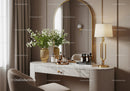 Elegant vanity table with golden accents and fresh flowers