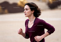 Focused woman jogging outdoors on a cool autumn day