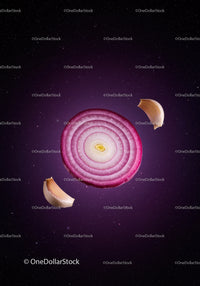 Red onion slice surrounded by garlic cloves on dark background