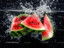 Juicy Watermelon Slices Splashing into Water Creating Refreshing Scene