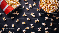 Popcorn scattered on black surface in snack scene