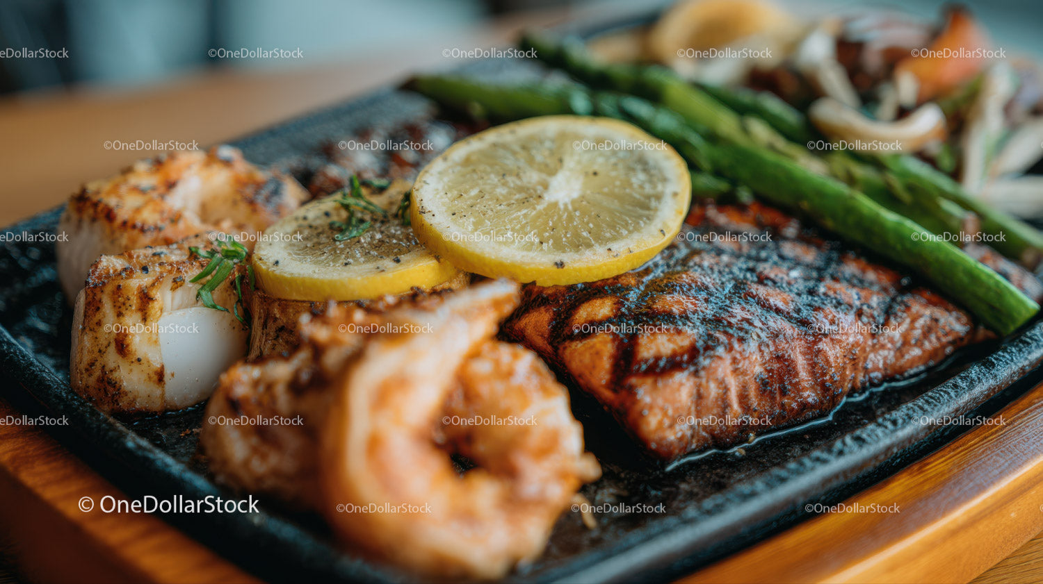 Grilled Salmon with Lemon Slices and Asparagus on Black Plate