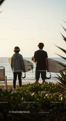 Two Surfers with Surfboards at Beach Ready for Waves