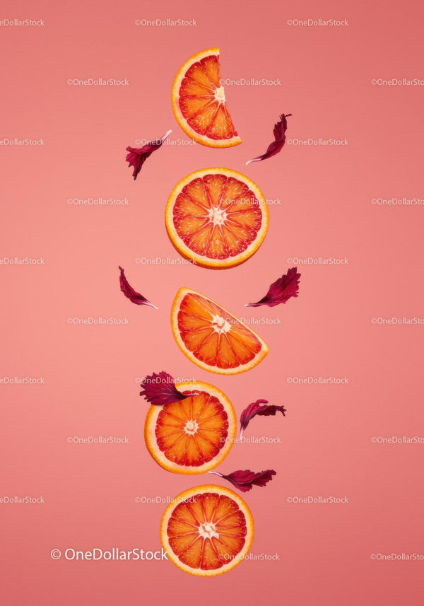 Fresh blood orange slices with red flower petals