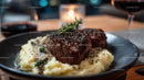 Juicy Beef Steak with Mashed Potatoes and Rosemary Garnish