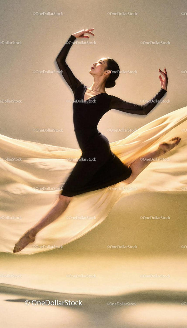 Graceful ballet dancer leaping with flowing fabric