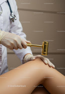 Chiropractor Using Therapeutic Gavel on Patient's Back in Clinic