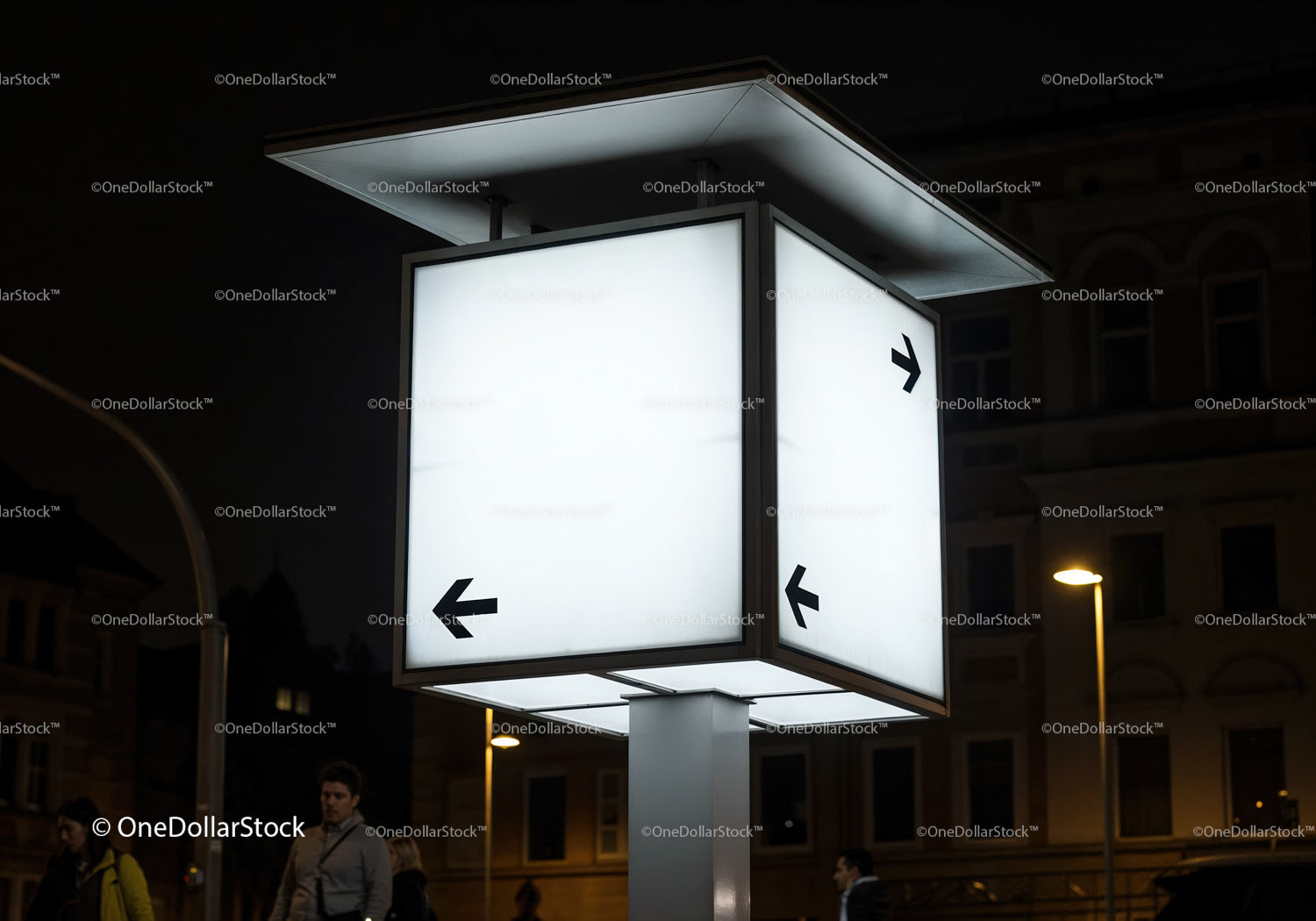 Illuminated directional signpost glowing at night