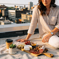 Woman Enjoying Urban Rooftop Picnic with Cheese and Coffee