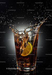 Refreshing cola splash with lime and ice cubes